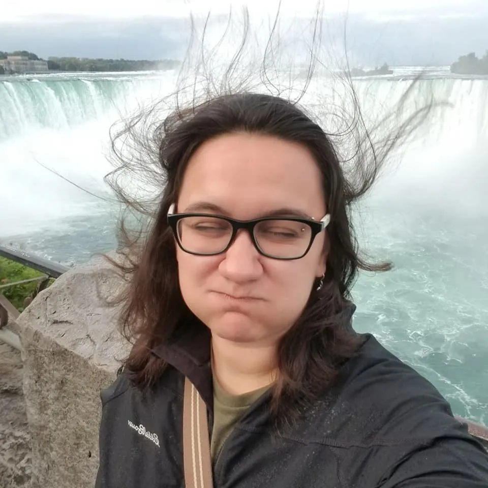 Alex at Niagara Falls, hair blown straight up by the spray